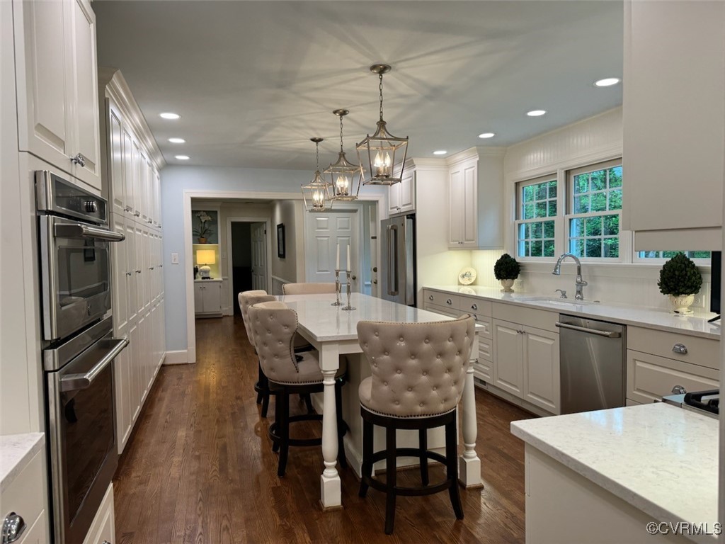 209 Running Cedar Lane Henrico, VA 23229 - Photo 6 of 29 a kitchen with a dining table chairs stainless steel appliances and cabinets