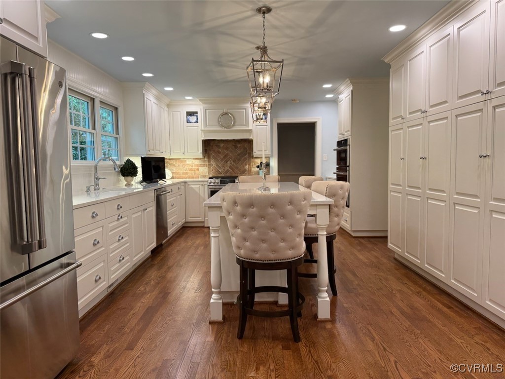 209 Running Cedar Lane Henrico, VA 23229 - Photo 7 of 29 a large kitchen with kitchen island granite countertop lots of white cabinets appliances and furniture