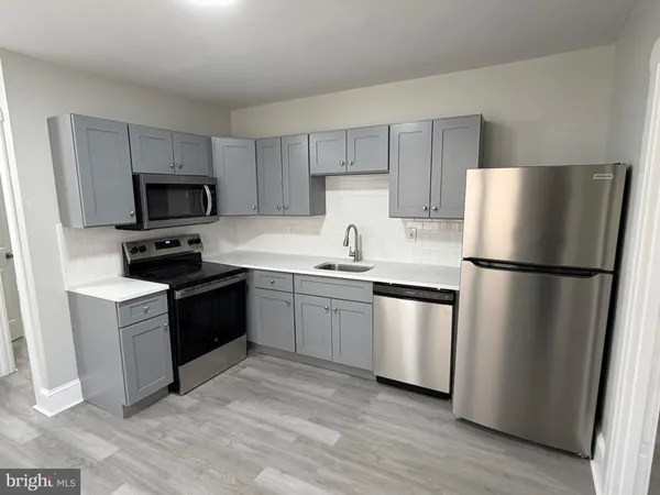 a kitchen with a refrigerator stove and sink