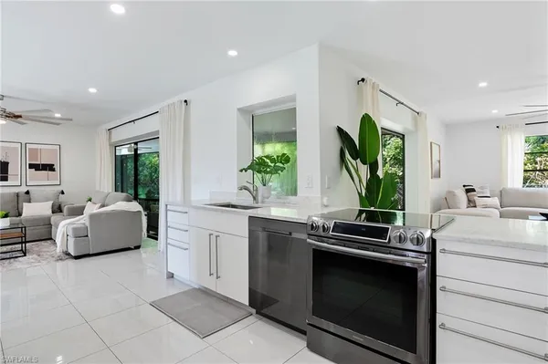 a kitchen with stainless steel appliances a stove sink and cabinets