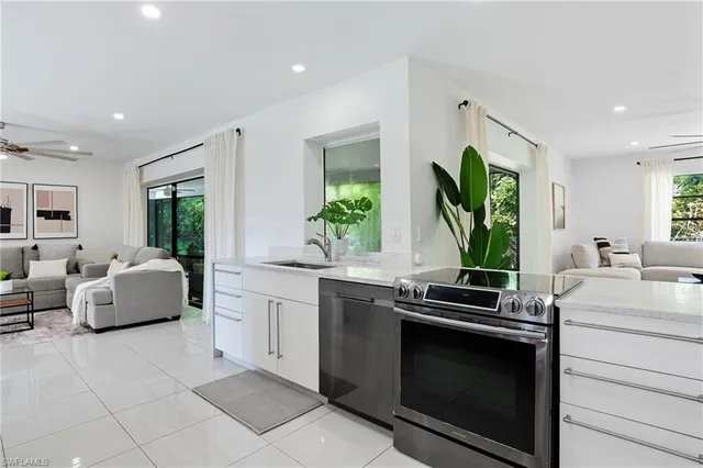 a kitchen with stainless steel appliances a stove sink and cabinets