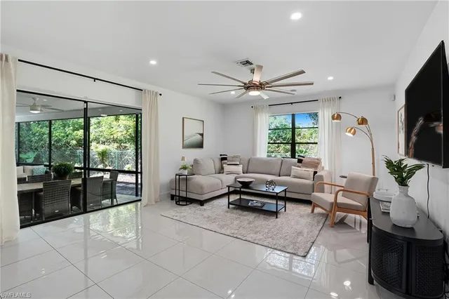 a living room with furniture fireplace and flat screen tv