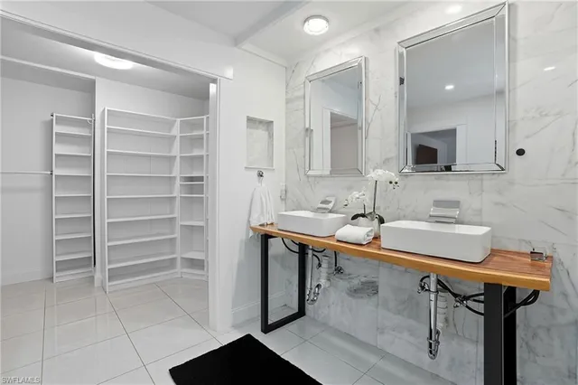 a bathroom with a sink shower and a mirror