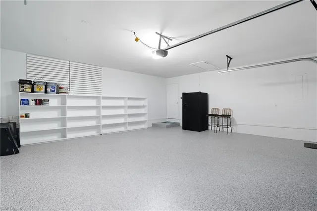 a view of empty room with cabinet and ceiling fan