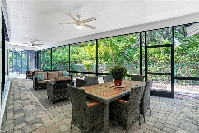 a view of a dining room with furniture and a large window