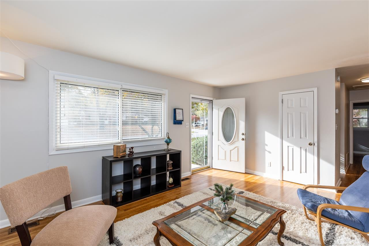 Warm light-filled room with refurbished hardwood floors. Living Room