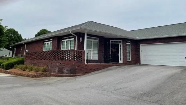 a front view of a house with a garden
