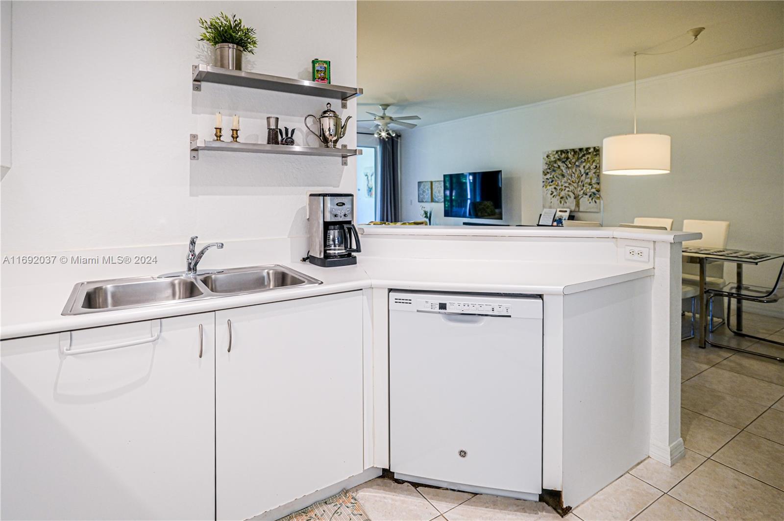 75 Gulfstream Road, Unit 107B Dania Beach, FL 33004 - Photo 20 of 71 a kitchen with cabinets and sink