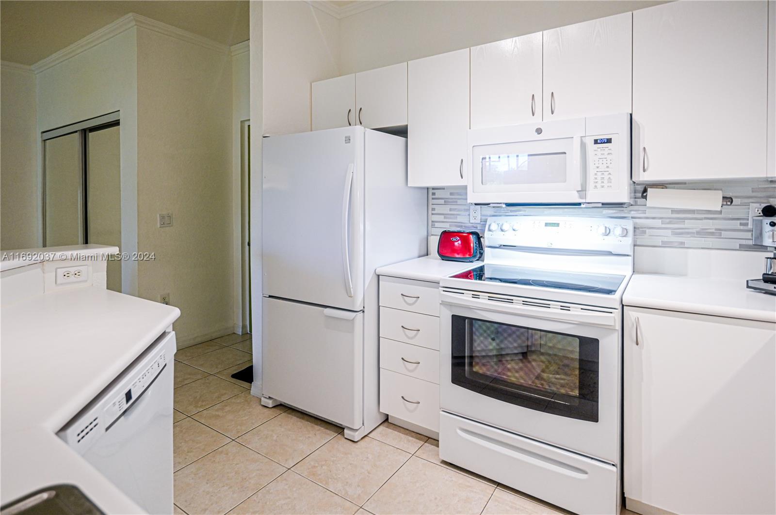 75 Gulfstream Road, Unit 107B Dania Beach, FL 33004 - Photo 21 of 71 a kitchen with cabinets and stainless steel appliances