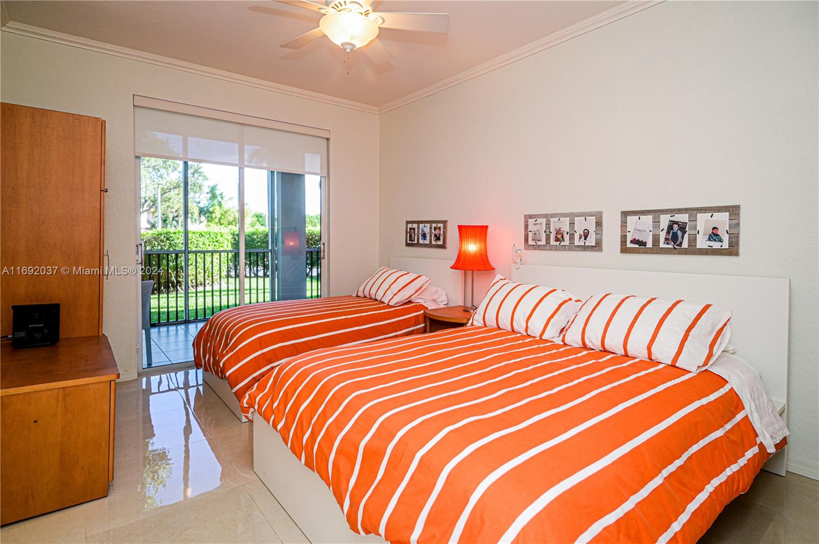 75 Gulfstream Road, Unit 107B Dania Beach, FL 33004 - Photo 33 of 71 a bedroom with two beds and a chandelier