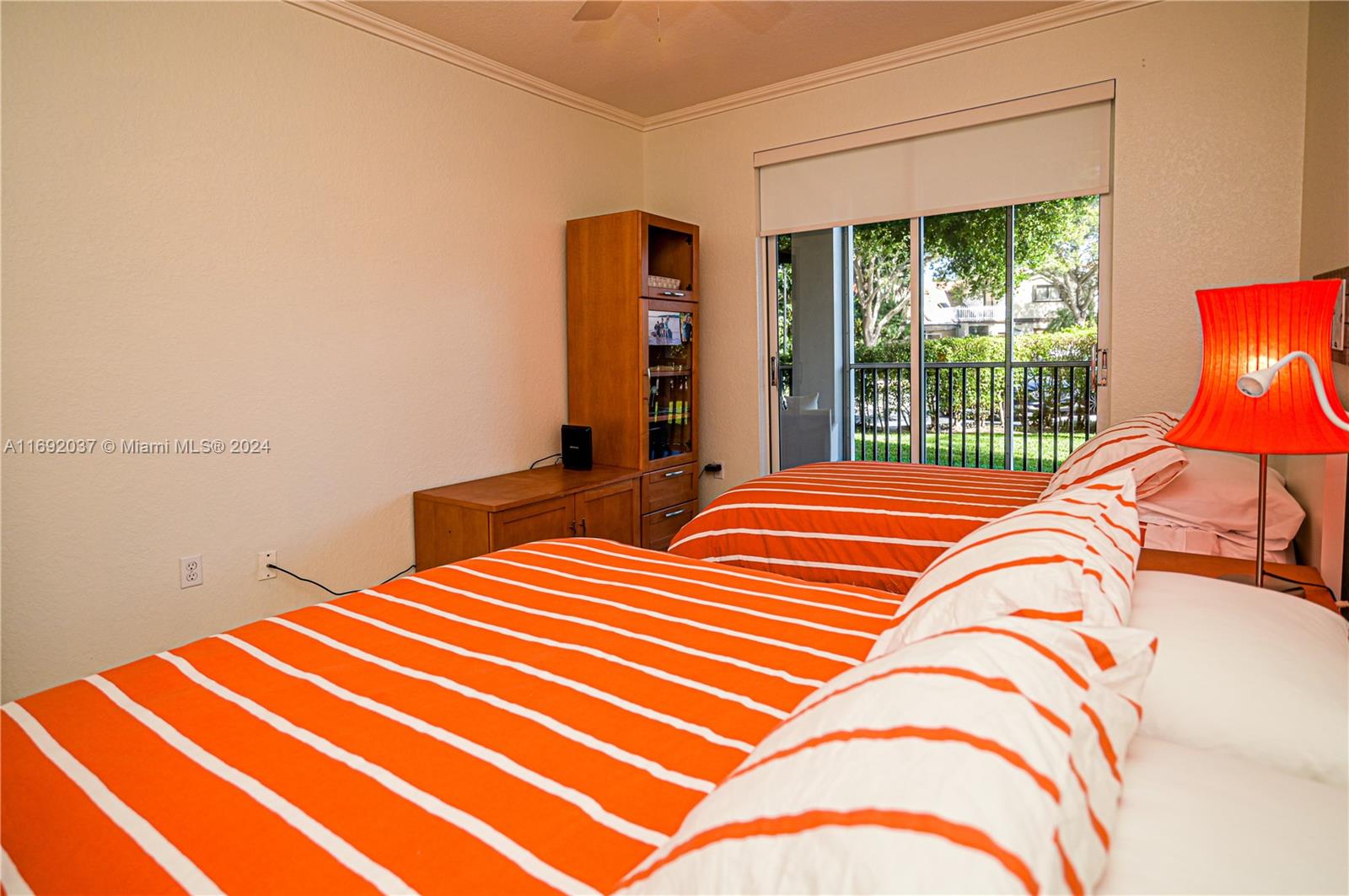 75 Gulfstream Road, Unit 107B Dania Beach, FL 33004 - Photo 34 of 71 a bedroom with a bed and a large window