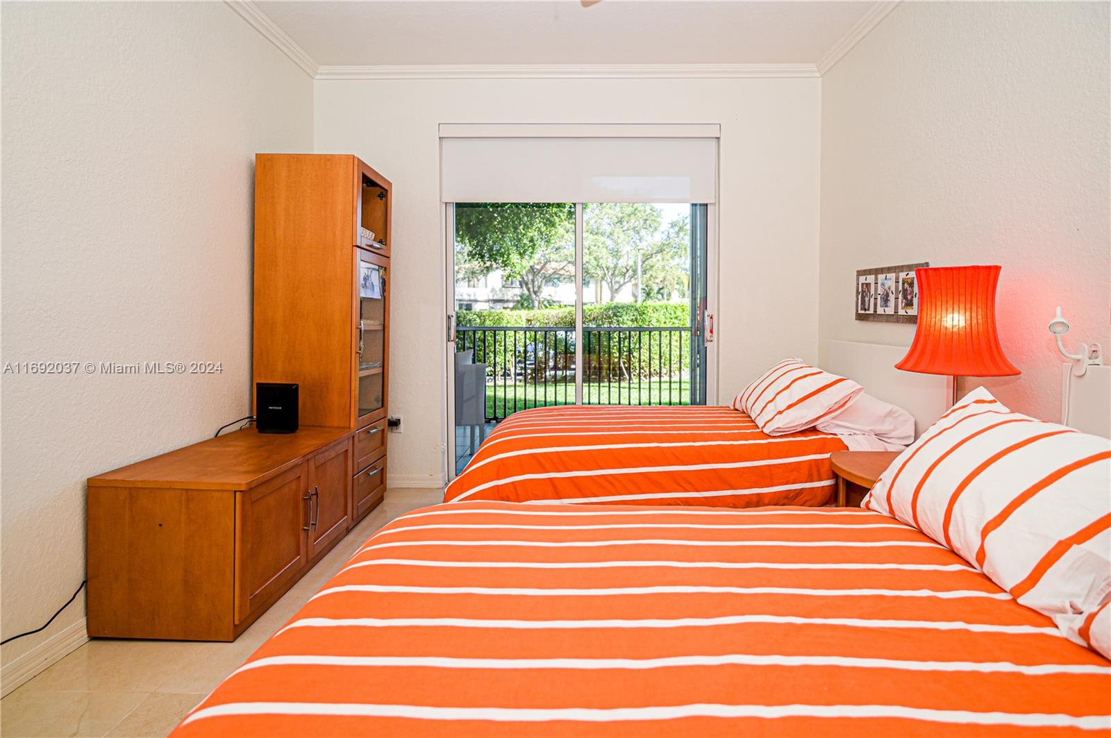 75 Gulfstream Road, Unit 107B Dania Beach, FL 33004 - Photo 39 of 71 a bedroom with a bed and a window
