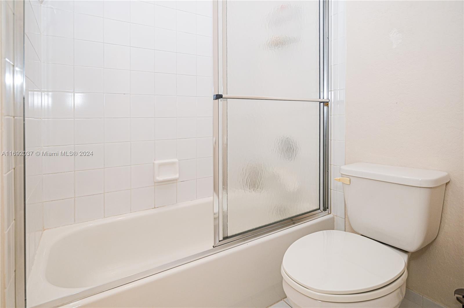 75 Gulfstream Road, Unit 107B Dania Beach, FL 33004 - Photo 48 of 71 a white toilet sitting next to a bath tub