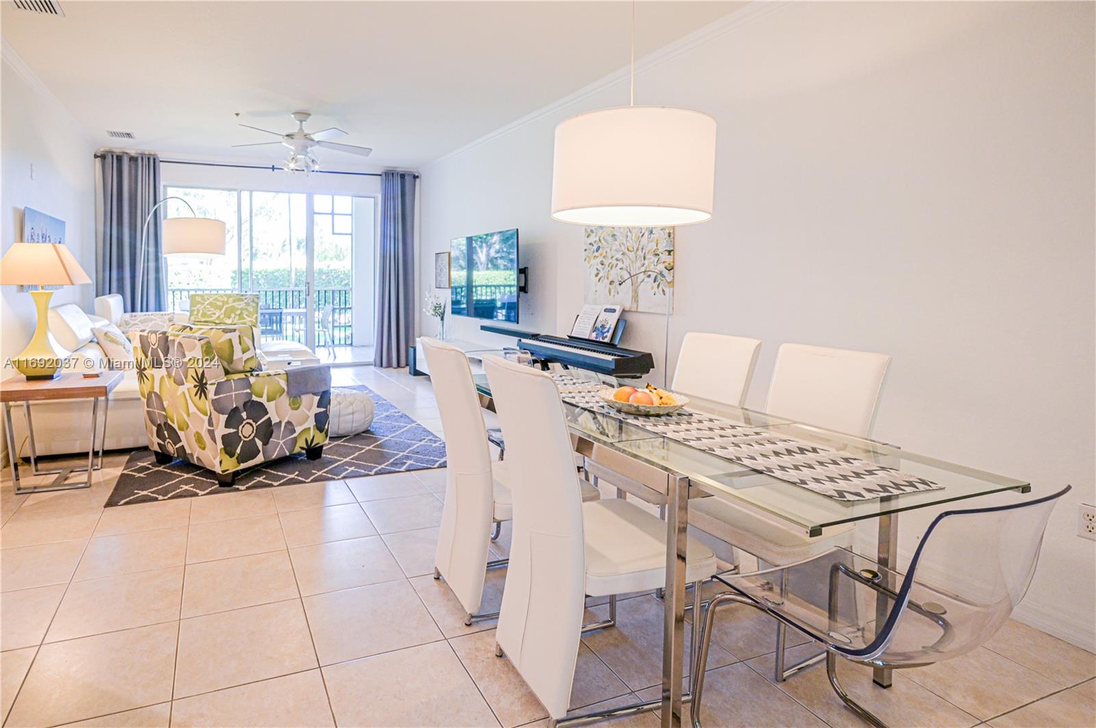 75 Gulfstream Road, Unit 107B Dania Beach, FL 33004 - Photo 5 of 71 a living room with furniture a window and a chandelier