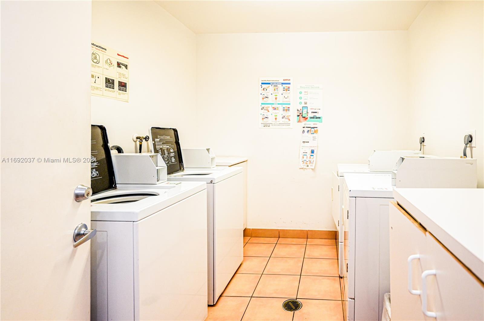 75 Gulfstream Road, Unit 107B Dania Beach, FL 33004 - Photo 55 of 71 a kitchen with a refrigerator and a stove top oven