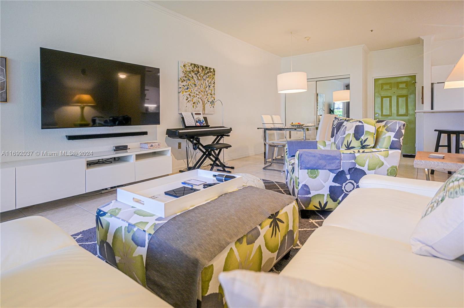 75 Gulfstream Road, Unit 107B Dania Beach, FL 33004 - Photo 7 of 71 a bedroom with a bed and a flat screen tv