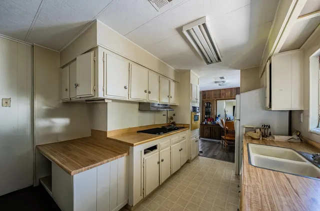 a dining room with a table chairs and a refrigerator