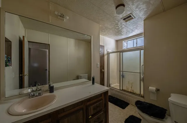 a bedroom with a bed and flat screen tv