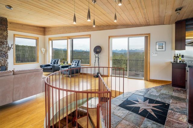 a kitchen with stainless steel appliances granite countertop a stove top oven a sink and a dining table