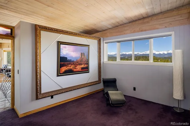 a bedroom with a bed and a dresser next to a window