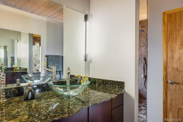 a bathroom with a tub a sink and a shower