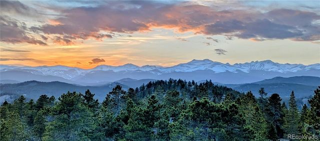 an aerial view of a house with mountain view