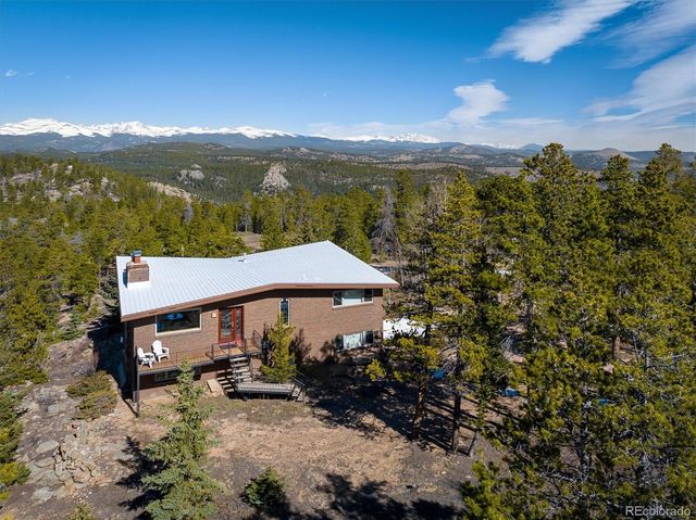 a view of a house with a yard and lake view