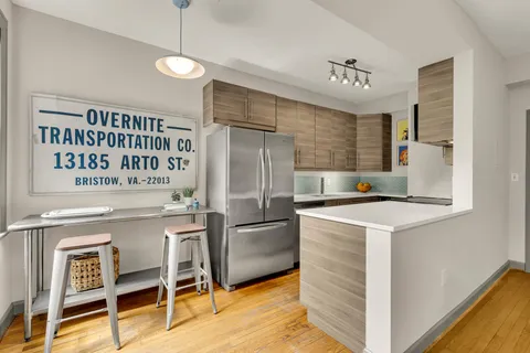 a kitchen with kitchen island a counter top space appliances and cabinets