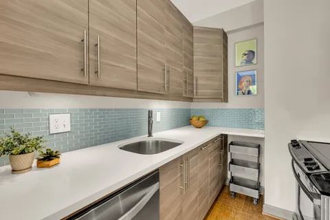 a kitchen with a sink and cabinets