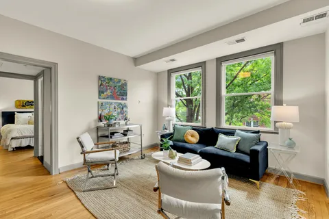 a living room with furniture and a large window