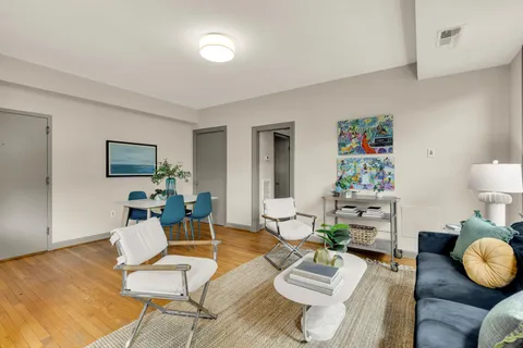 a living room with furniture and wooden floor