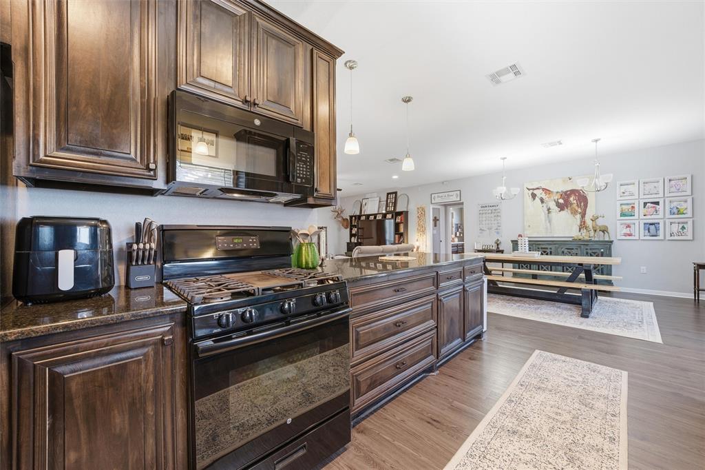 12992 Old Dallas Road West, TX 76691 - Photo 11 of 25 a kitchen with wooden cabinets and a stove top oven