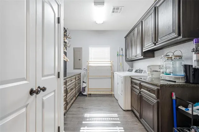 a kitchen with granite countertop a refrigerator and a stove top oven
