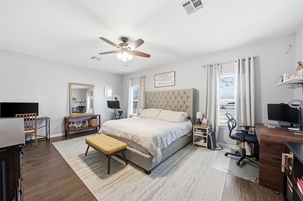 12992 Old Dallas Road West, TX 76691 - Photo 14 of 25 a bedroom with a bed and wooden floor