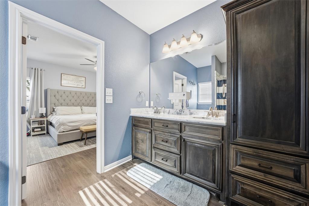 12992 Old Dallas Road West, TX 76691 - Photo 15 of 25 a en suite bathroom with a double vanity sink and a mirror