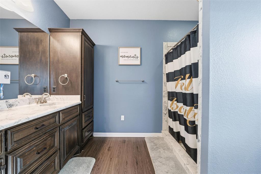 12992 Old Dallas Road West, TX 76691 - Photo 16 of 25 a bathroom with a sink and a mirror