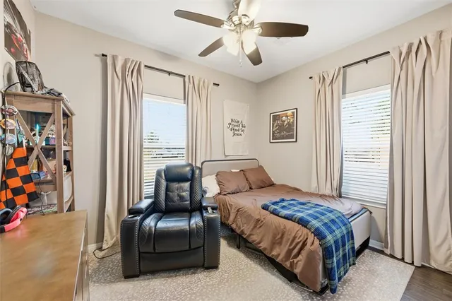 a bedroom with a bed couch and a window