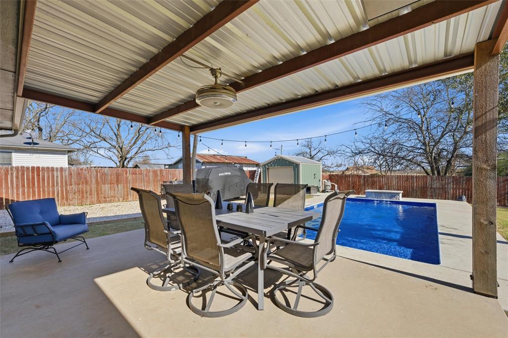 12992 Old Dallas Road West, TX 76691 - Photo 21 of 25 a view of a patio with table and chairs and wooden floor
