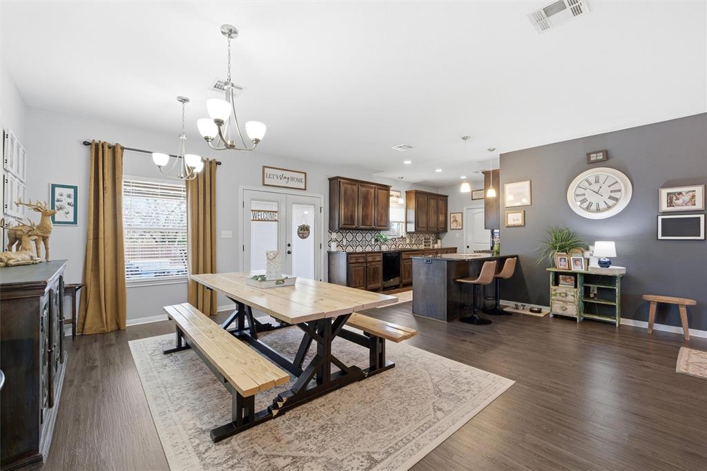 12992 Old Dallas Road West, TX 76691 - Photo 6 of 25 a living room with furniture a fireplace a flat screen tv and kitchen view