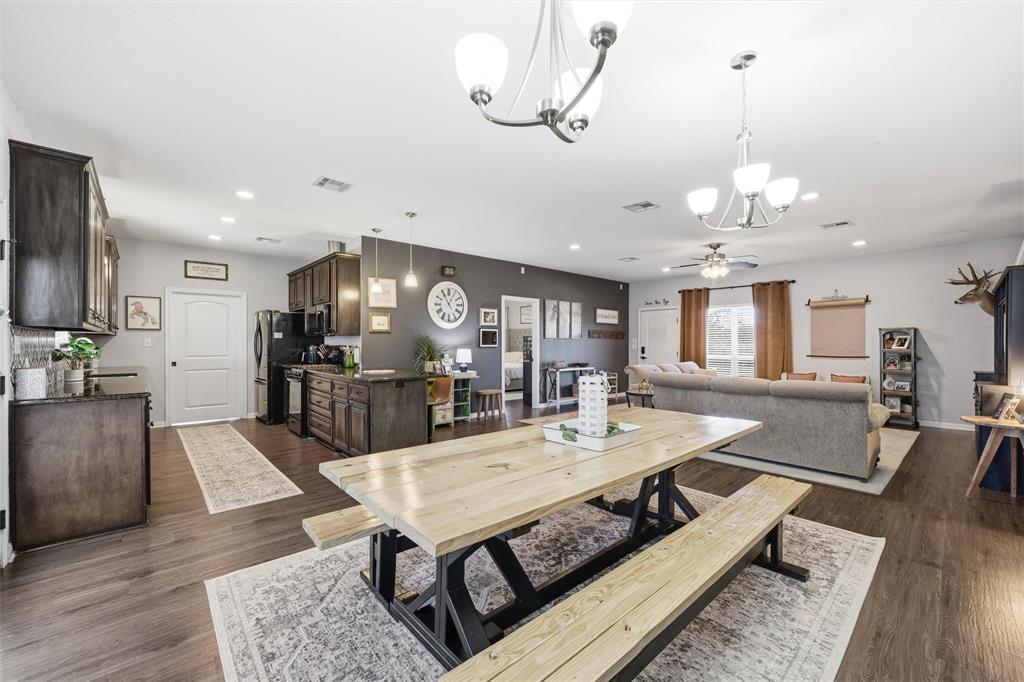 12992 Old Dallas Road West, TX 76691 - Photo 7 of 25 a view of a dining room and livingroom with furniture wooden floor a chandelier