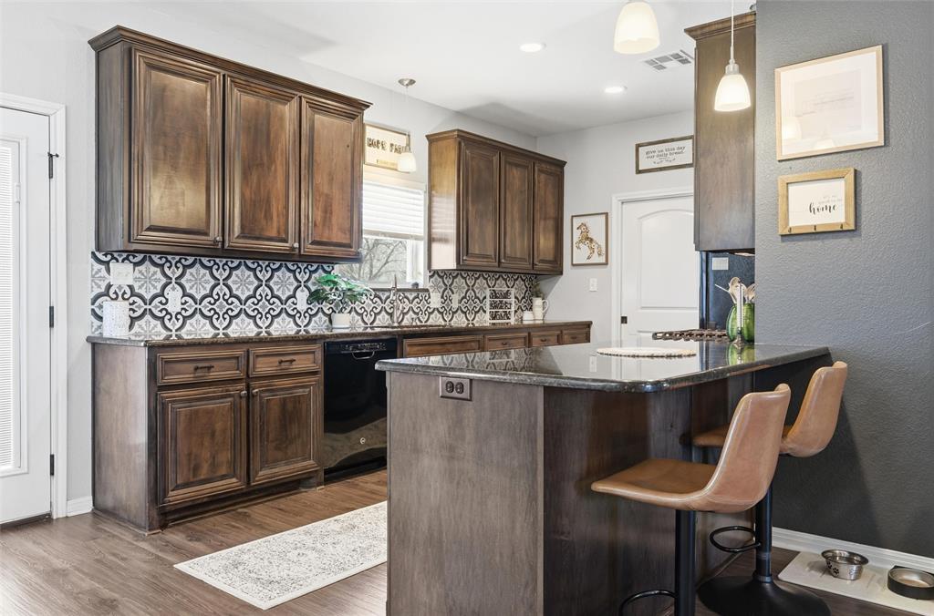 12992 Old Dallas Road West, TX 76691 - Photo 9 of 25 a kitchen with stainless steel appliances granite countertop a sink stove and cabinets