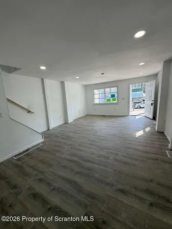 a view of a big room with windows and cabinet