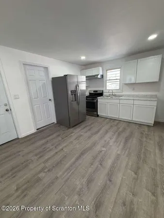 a view of kitchen with furniture and wooden floor