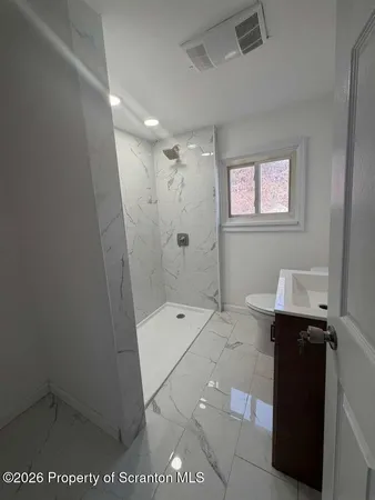 a bathroom with a sink and shower