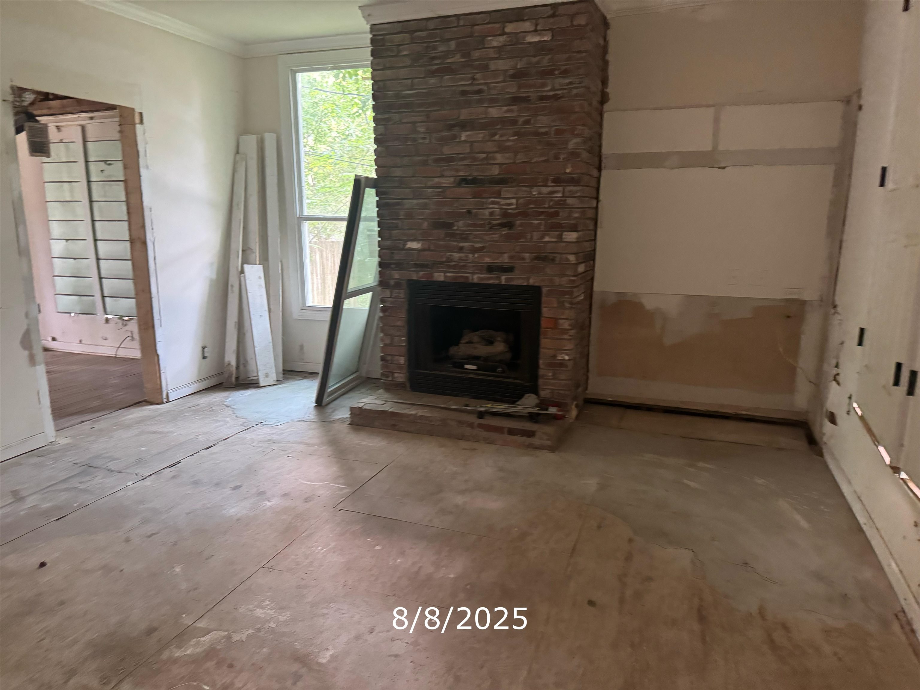 264 North Collierville Arlington Road Collierville, TN 38017 - Photo 4 of 5 Unfurnished living room featuring crown molding and a fireplace