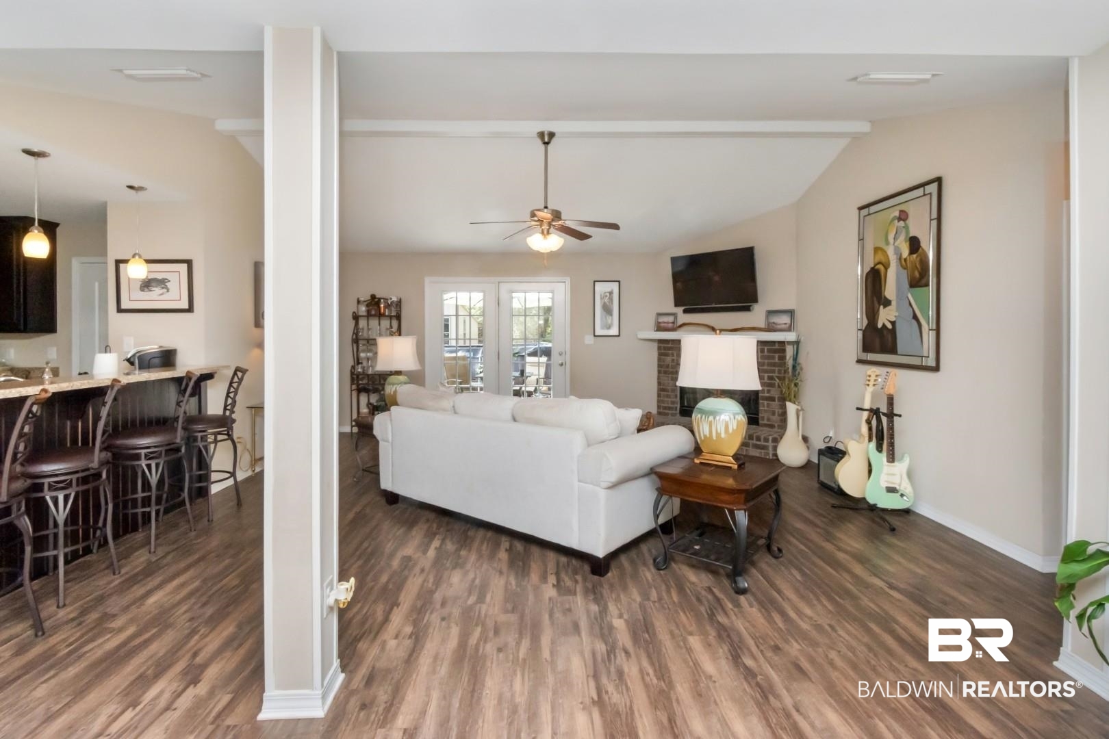 11528 Mocking Bird Lane Fairhope, AL 36532 - Photo 10 of 45 Living area featuring vaulted ceiling with beams, ceiling fan, dark wood-style floors, and a brick fireplace