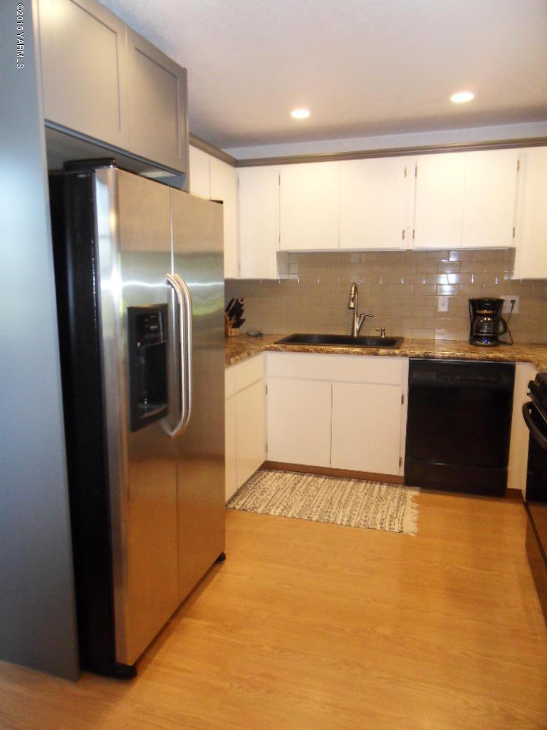 3501 Wiley Road Yakima, WA 98903 - Photo 9 of 31 a kitchen with stainless steel appliances granite countertop a refrigerator a sink a stove and island