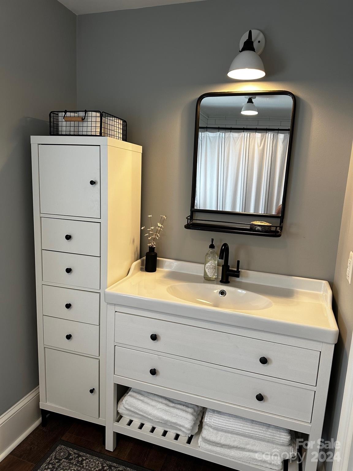 303 Legion Road Hudson, NC 28638 - Photo 12 of 32 a bathroom with a sink and a mirror