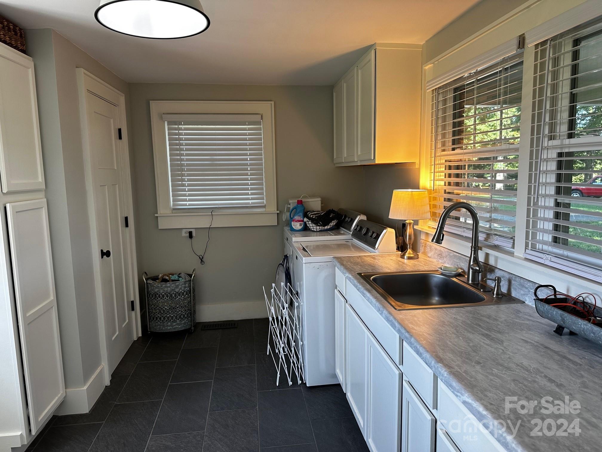 303 Legion Road Hudson, NC 28638 - Photo 16 of 32 a kitchen with a sink stove and cabinets