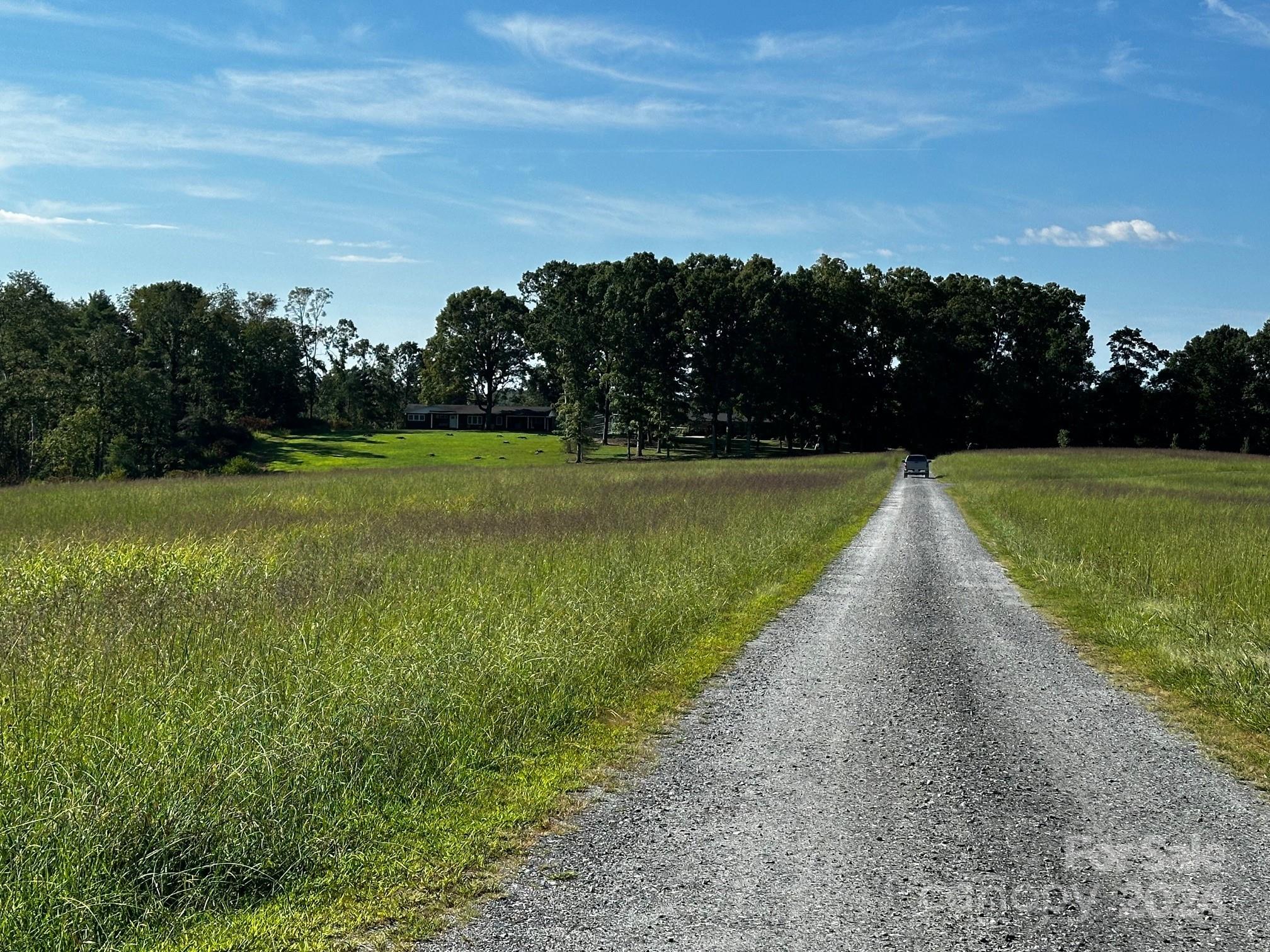 303 Legion Road Hudson, NC 28638 - Photo 21 of 32 a view of a golf course with a lake